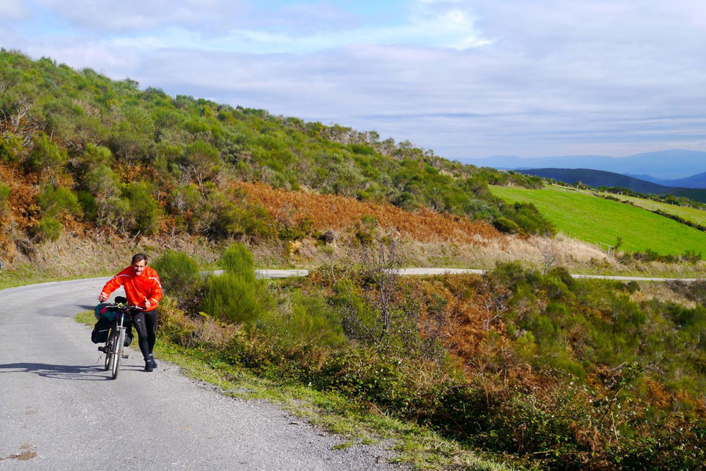 A fellow tourer pushing up a tough climb